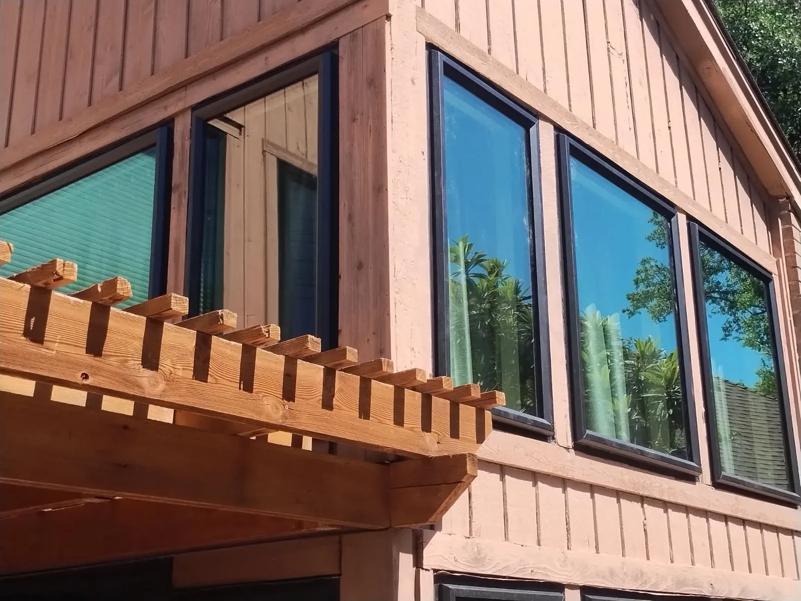 Bronze ProVia Endura windows wrapping an upper corner of a Stonebridge Ranch contemporary home