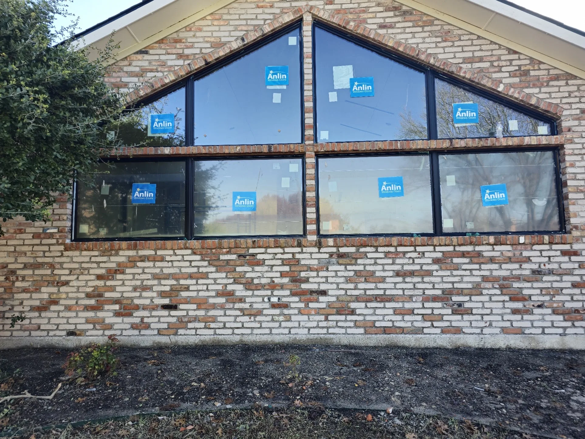 Finished black-frame Anlin gable windows on Willow Bend brick home